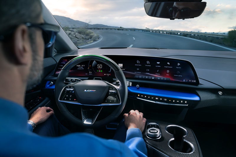 Front View of the 2026 OPTIQ-V Driving Through the Dusk Utilizing its Headlights | Ken Barrett Chevrolet Cadillac in BATAVIA NY